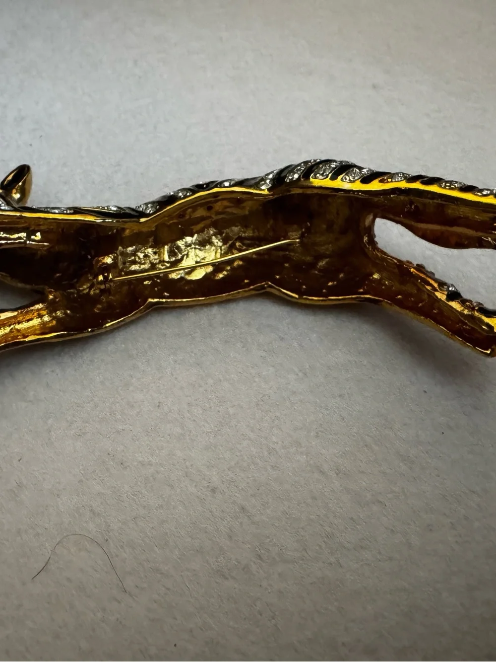 Vintage 1980s gold and black enamel over the shoulder brooch